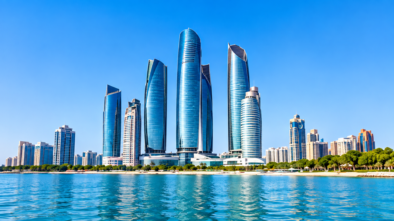Modern skyscrapers along the Abu Dhabi waterfront with palm trees and blue sea